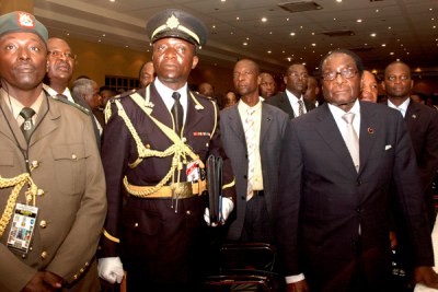 The names of 35 people close to the ruling elite of President Robert Mugabe, right, have been removed from a European sanctions list.