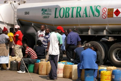 Zimbabweans fill up with petrol at the Botswana border.