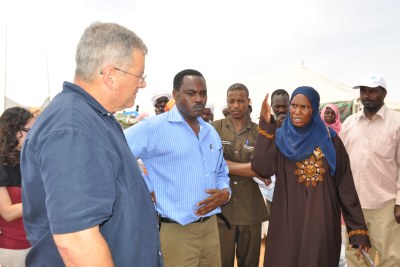 President Barack Obama's envoy to Sudan, Maj. Gen. Scott Gration, seen hearing during a previous visit from displaced people in the Abu Shouk camp in northern Darfur.
