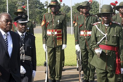 Former Zambian President Rupiah Banda inspects a guard of honour during the swearing-in ceremony.