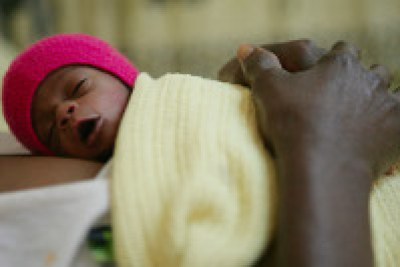 Malawi: A newborn lies on his mothers chest.