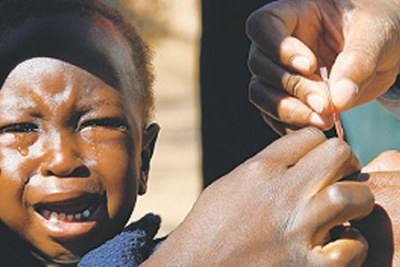 A child receives medical attention in Kenya.