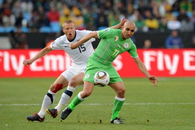 Rafik Djebbour of Algeria is challenged by Jay Demerit of United States (file photo).