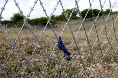 Barbed fencing lines the South Africa - Zimbabwe border.