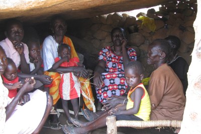 Displaced family in cave on the top of al-Labu Umudwal mountain, Southern Kordofan. Since early July, three thousand people have been living in caves and under boulders on the mountain to escape near daily Sudanese government bombing in their home areas. The displaced say Antonov planes have also bombed the mountain side. At least 150,000 people have fled their homes and indiscriminate aerial bombardment since early June.
