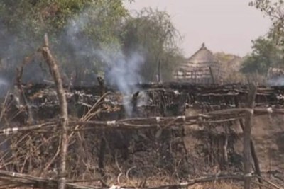 A burning tukul (hut) in Pibor, South Sudan