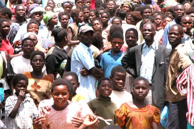 Hundreds of people queue for a monthly ration of maize-meal in Malawi.