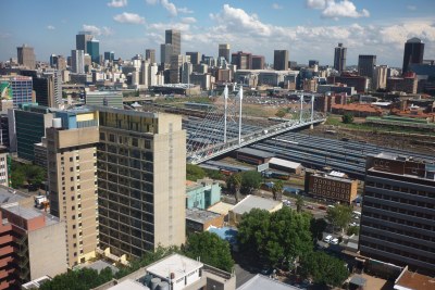 Looking out over Johannesburg from Braamfontein. Nelson Mandela bridge over the train station. CBD in the background
