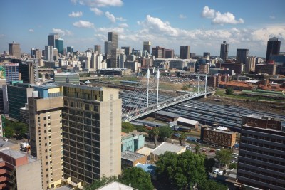 Looking out over Johannesburg from Braamfontein. Nelson Mandela bridge over the train station. CBD in the background