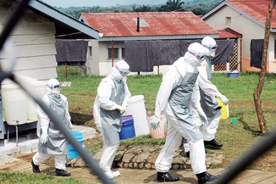 Medical workers in protective gear leave an Ebola isolation camp during the 2007 outbreak (file photo).