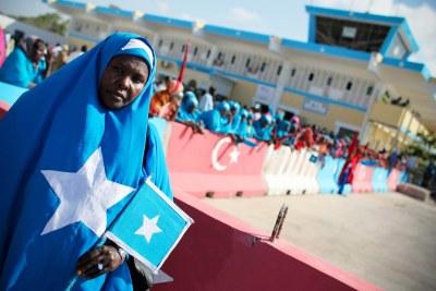 A woman dressed in the colours of the Somali flag.