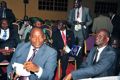 DRC President Joseph Kabila, left, with South Sudan minister of commerce and investments, Garanga Dung Akwang in Kampala.