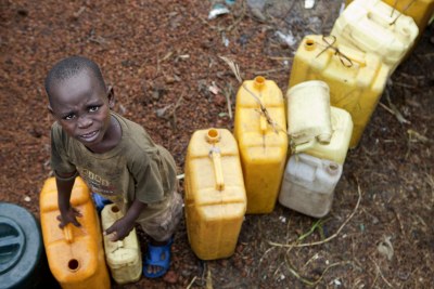At the Kanyaruchinya internally displaced persons camp in Goma, a young boy waits to fill his containers at a water distribution area.