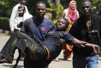 A survivor is carried out of Westgate Mall in Nairobi, Kenya, where armed gunmen opened fire and reportedly killed up to 30 people and wounded dozens.
