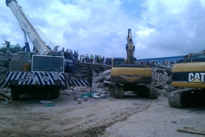 Excavators, aided by workers with jackhammers, clear the debris of the collapsed building (file photo).