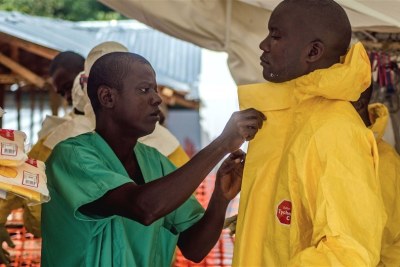 A health worker putting on protective clothing before treating sick Ebola patients (file photo).