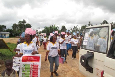 Volunteers knocking on doors and advising people to wash their hands as a precaution against the Ebola virus .