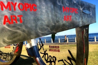 The Tokolos Stencil Collective is an anonymous group of stencil and graffiti artists, activists and other concerned citizens in South Africa. They have claimed responsibility for defacing several landmarks in Cape Town, including this installation in Sea Point - saying they have intervened in 
