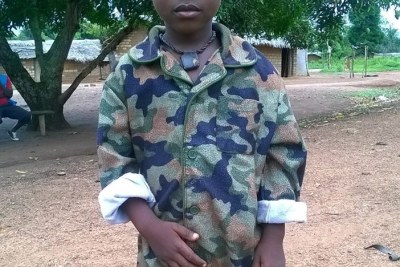 This little boy - his face obscured to protect his identity - is not even five years old and he is already enrolled in an armed group.