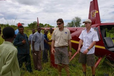 Helicopter pilot Roger Gower, right, assists with anti-poaching activities in Tanzania’s Katavi National Park. On January 28, he died after he was shot by poachers while trying to track them down. (file photo)