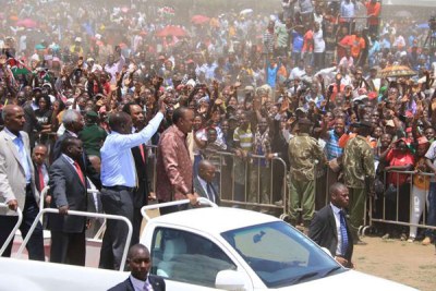 The 'Ocampo Six' ride on a pick up at the Afraha Stadium in Nakuru on April 16, 2016 where they attended a thanksgiving ceremony for the dropping of all their cases by the International Criminal Court.