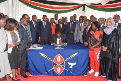 President Uhuru Kenyatta signs the Anti-Doping Bill into law at State House in Nairobi on April 22, 2016.