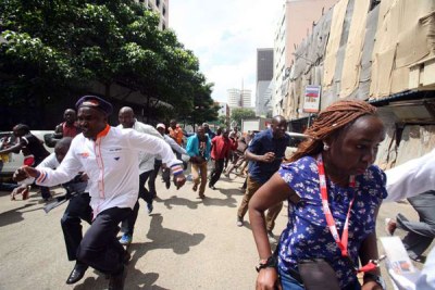 ODM chairman John Mbadi and other Cord supporters take to their heels after a tear gas canister was lobbed at them during Cord protests in Nairobi on May 23, 2016.