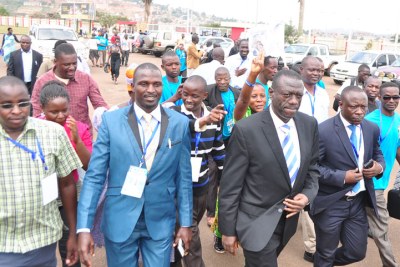Dr Kizza Besigye (2nd R) with supporters in Kampala. Some FDC party officials are accused of leaking party secrets to state agents.