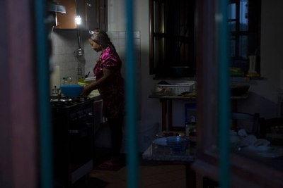 Princess, a Nigerian former sex slave trafficked into prostitution to pay off her 45,000 euro debt, washes dishes at her home in Italy, where she gained asylum after escaping her ordeal and set up a charity to help other victims.