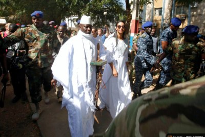 Gambian President Jammeh arrives at a polling station with his wife Zineb during the presidential election in Banjul.