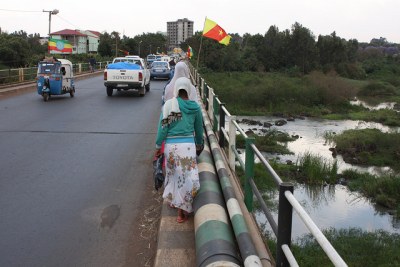Ethiopian national flags and regional Amhara flags flutter along the bridge over the Blue Nile on the road going east from Bahir Dar.