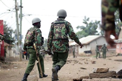 Anti-riot police officers patrol Nyalenda, in Kisumu County (file photo).