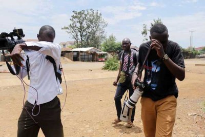 Journalists react after they were teargassed by anti-riot police who did not want to be filmed during a demonstration in Kisumu on October 13, 2017 (file photo).