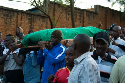 Rayon Sports players, including Ismailla Diarra (left) and Tidiane Kone (right), carry the body of the Blues' former assistant coach Hamadi Katauti Ndikumana from his home in Nyakabanda to Qaddafi mosque in Nyamirambo.