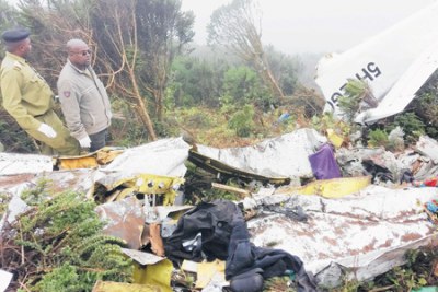 Security officers inspect the remains of aircraft owned by Coastal Aviation that crashed at Empakaai Crater near Ngorongoro Crater in Arusha Region on Wednesday.