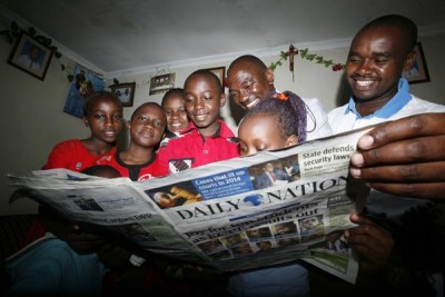 Family looking at the published KCPE examination candidates who performed well (file photo).