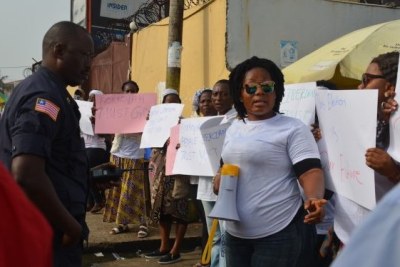 Women protest outside the Elections Commission offices.