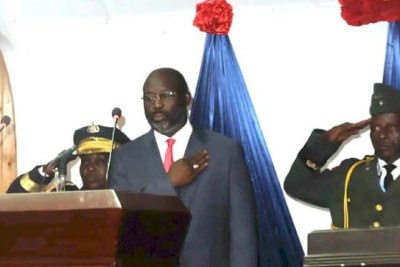 President Weah poses for the playing of the national anthem.