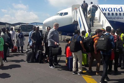 Passengers board RwandAir.