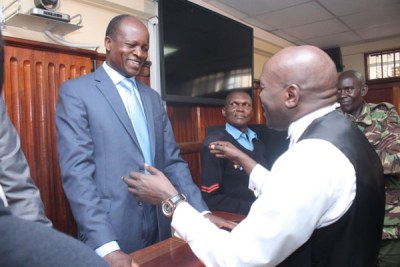 Migori Governor breaks into a smile as he speaks with his lawyer at the High Court in Nairobi shortly after he was freed on bond in Sharon Otieno murder case.
