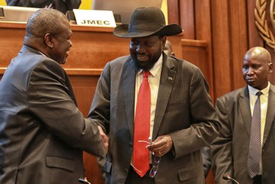 President Salva Kiir, right, of South Sudan shakes hands with Riek Machar after concluding a peace deal to end the conflict in the country in September 2018.