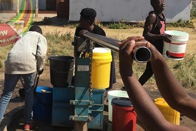 Highfield residents queue for water.