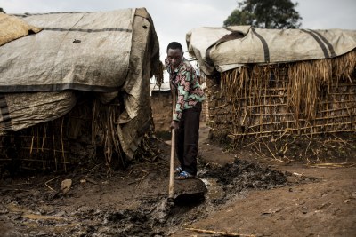 People living in the IDP camp of Bukombo, Masisi territory, try to fix their house in the first days of the raining season. The camp doesn't have enough latrines and fecal waters overflow across the camp.