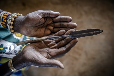 A woman holding blades used in female genital mutilation practices(file photo).
