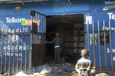 Children stand at the door of a looted shop in Alexandra, Johannesburg in July, 2021.