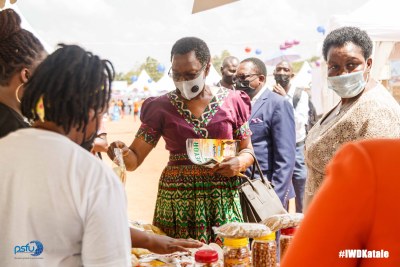 Hon. Victoria Sekitoleko inspecting the different business stalls at the Women's Day Katale in Luwero, Uganda.