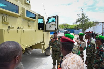 Senior ATMIS, Djibouti and US officials inspect one of twenty-four Armoured Personnel Carriers (APCs) donated by the U.S. to boost operations in areas under the security responsibility of Djibouti Armed Forces serving with the African Union Transition Mission in Somalia (ATMIS). The handover ceremony took place in Mogadishu, Somalia on 3 August 2022.