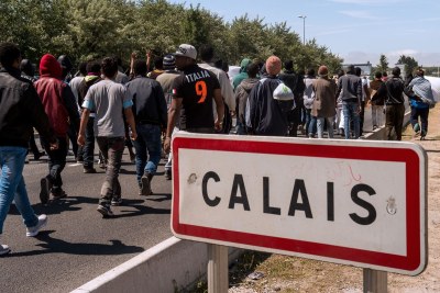Migrants walk toward the ferry port of Calais in June 2015.